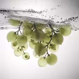 a bunch of grapes hanging in the water