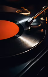 an antique turntable with orange disc in a black room