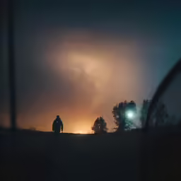 a person on a bike riding towards the light