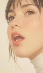a woman with blue eyes has her face up and wears an ear jacket