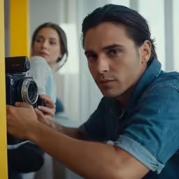 a man is taking a photograph while another person takes it