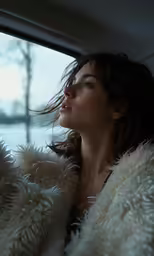 the woman is wearing her hair in the window