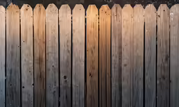 a very old looking wooden fence with some lights