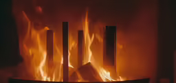 flames from the fire of a fireplace with a black background