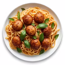 a plate of spaghetti with small meatballs and basil leaves