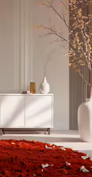 the large vase has a thin red flower in it