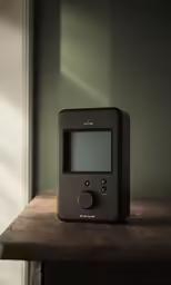 a clock on top of a table with a wood table