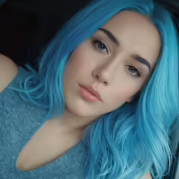 a woman with blue hair in a car