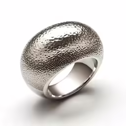 a ring with shiny silver surface and curved edges
