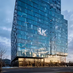 an elegant modern office building with large windows in the front