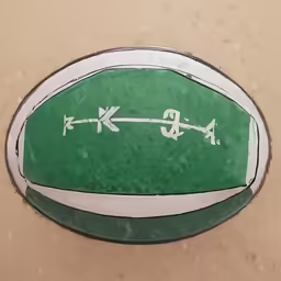 this is a green painted rugby ball on the ground