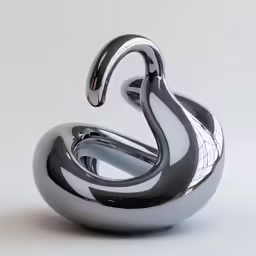 a silver sculpture is sitting on a table