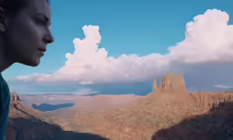 woman with view on a mountain from the edge of the grand canyon