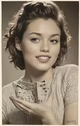 a woman with her hands around her chest posing for a photo