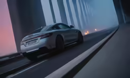 a gray car driving down the road in the mist