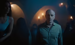 a man standing next to a woman in a dark room