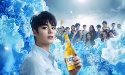 asian woman holding a bottle of beer against blue and white foamy bubbles