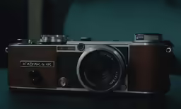 an old fashioned camera on a black table