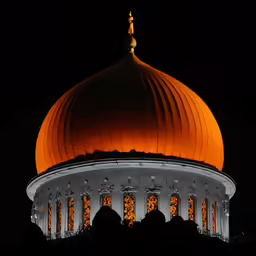 the dome of a building lit up at night