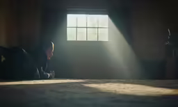 the girl is sitting under the window in the house