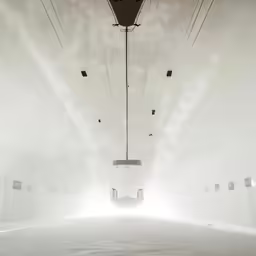 a tram has its lights on in a foggy location