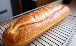 a piece of bread is cooling on a cooling rack