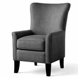 an upholstered, modern style armchair with wood legs