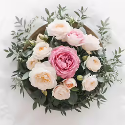 a bouquet of flowers sit on top of a table