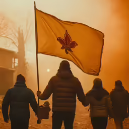 a couple and their children walking away from a canada maple flag