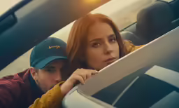 a man in a cap standing next to a woman