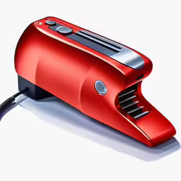 a red device on the ground with a cord coming out