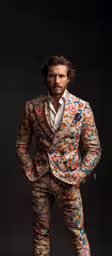 a man wearing a colorful suit and tie,the man with his suit is wearing a flowery tuxedo