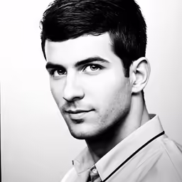 a young man in a dress shirt and tie