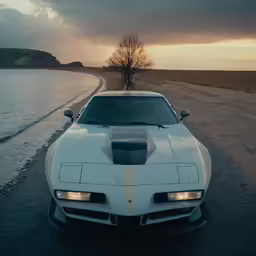 a white sports car parked by the water