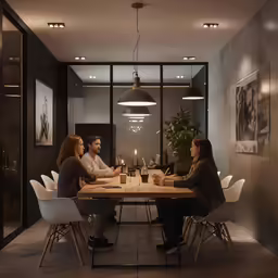 a group of friends sitting at a table enjoying a meal