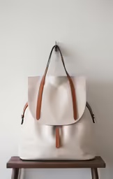 a white bag is hung up on the wall