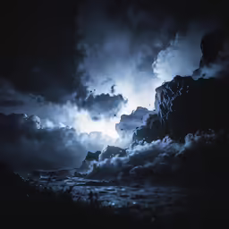 a dramatic black and white photo of an intense storm coming over a mountain