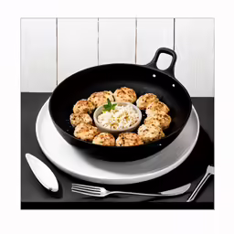 a frying pan full of food and silverware