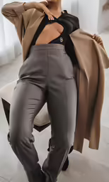woman posing for the camera in an office suit