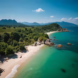 an aerial shot of the beach and mountain range