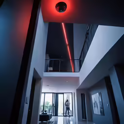 the atrium of an apartment with a black sofa