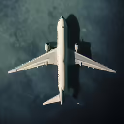 the plane is flying through the air during the day