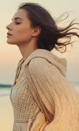 woman standing on the beach with long flowing hair