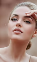 a close up of a woman holding her eye