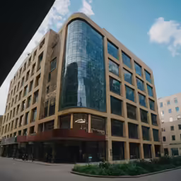 a large building with two floors in front of buildings