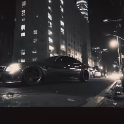 a black sports car sitting on the side of a road at night