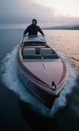 the man is riding in his boat on the water