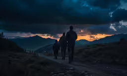 three men walking away down a dirt road under dark clouds