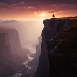 man standing on edge of cliff watching over ocean