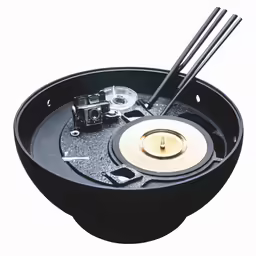 a bowl holds a record player and chopsticks